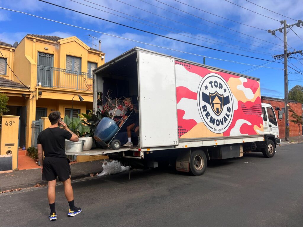 Top Removals moving heavy pieces of furniture from an home