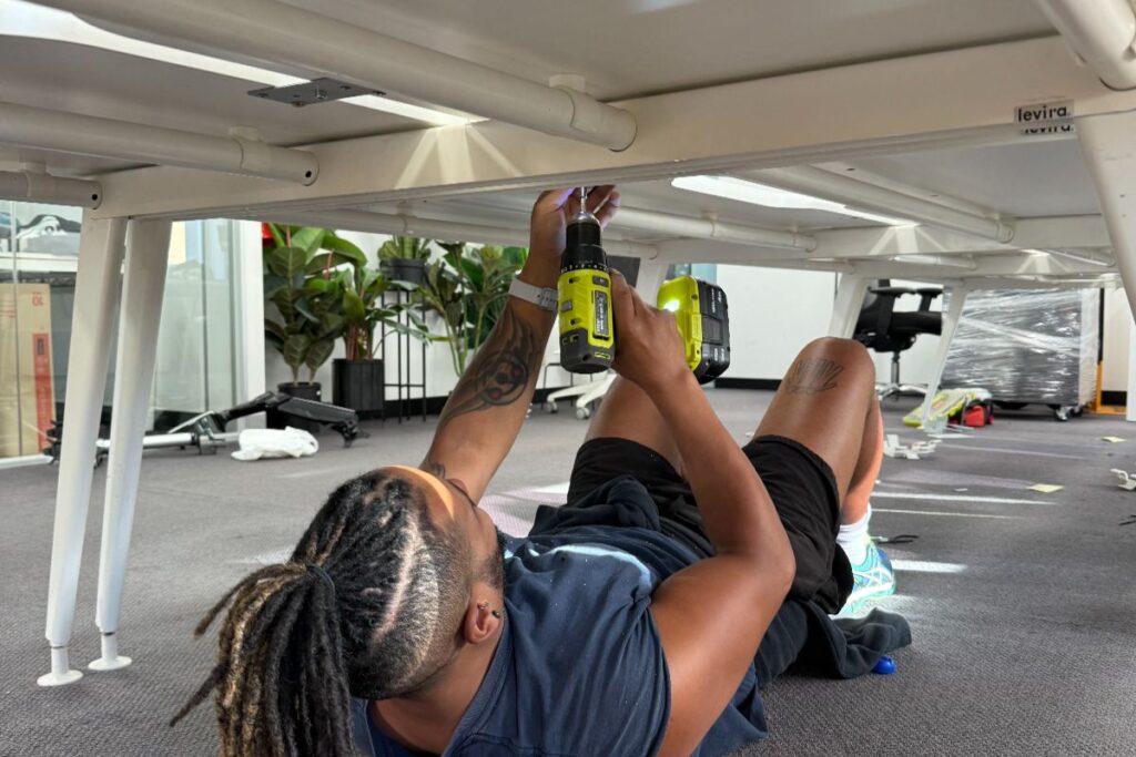 A trusted Top Removals removalist disssembling a table before the move